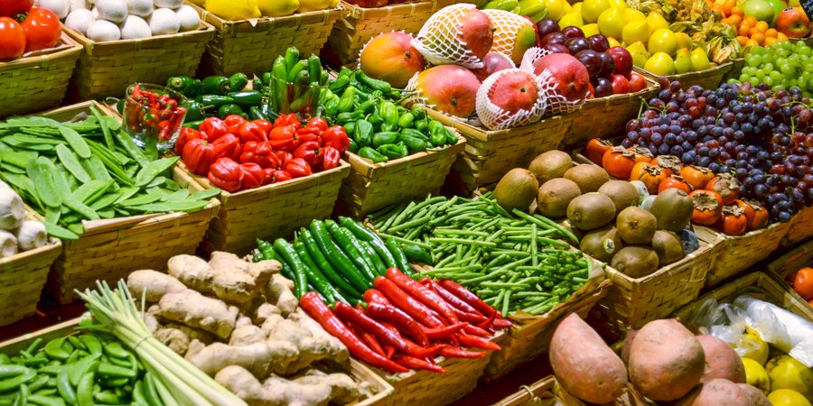 Large display of several rows of fruits and vegetables
