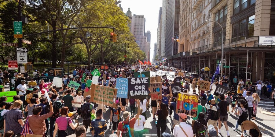 Marchers hold signs at New York City Climate March