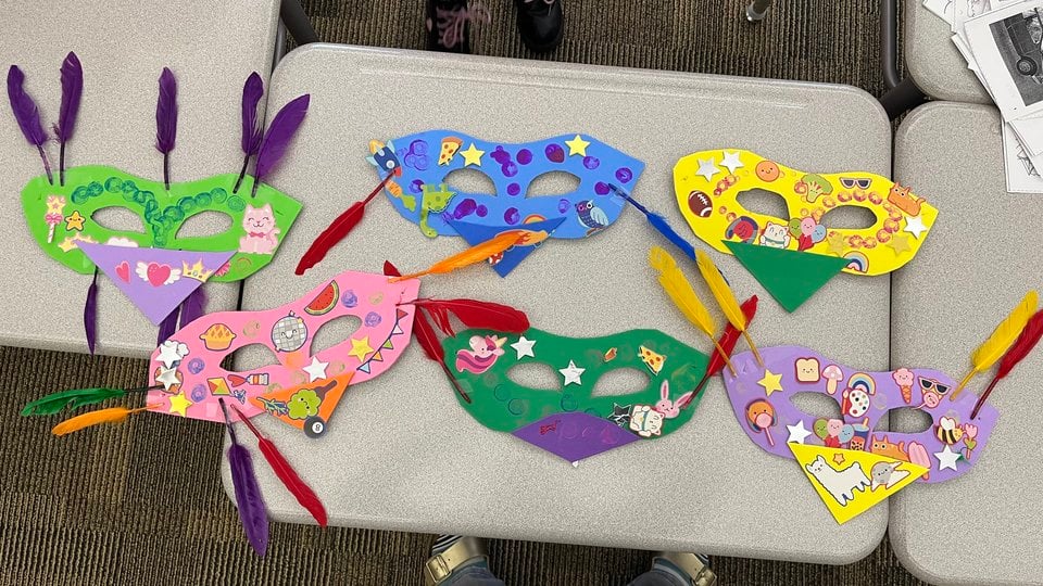 An overhead view of bird masks created by students in Savoonga