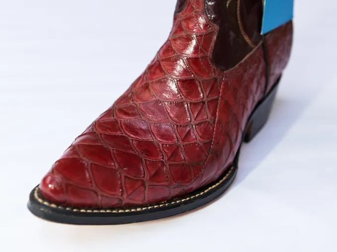 A red boot made out of illegal pangolin skin.