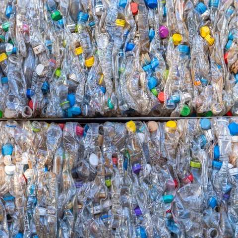 Close-up of recycled plastic bottles that have been crushed into cubes.
