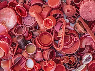 A pile of reddish-pink plastic waste.