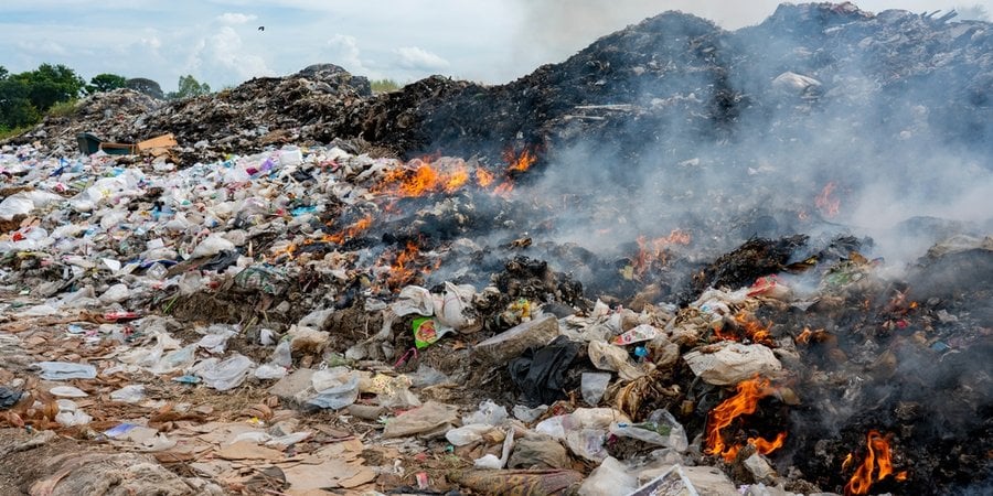 a pile of plastic and trash on fire