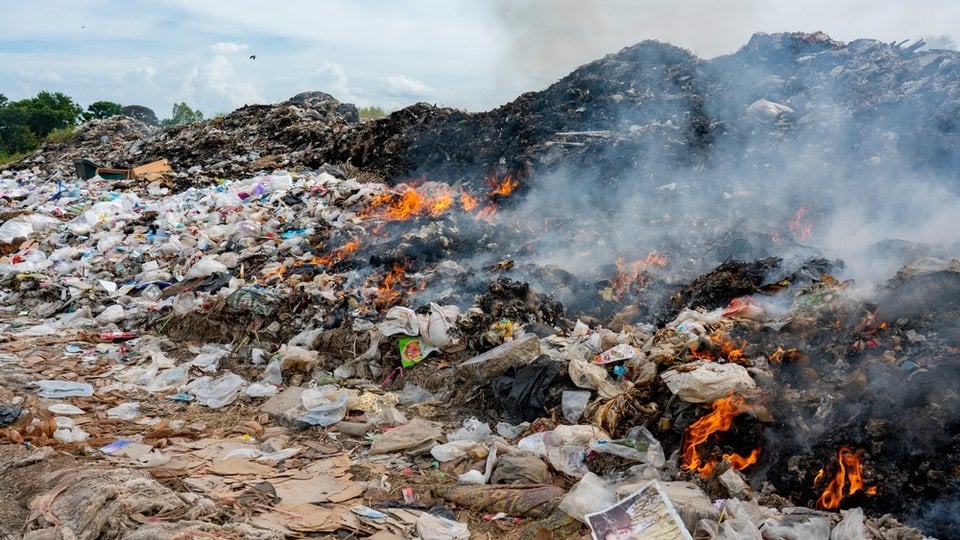 a pile of plastic and trash on fire