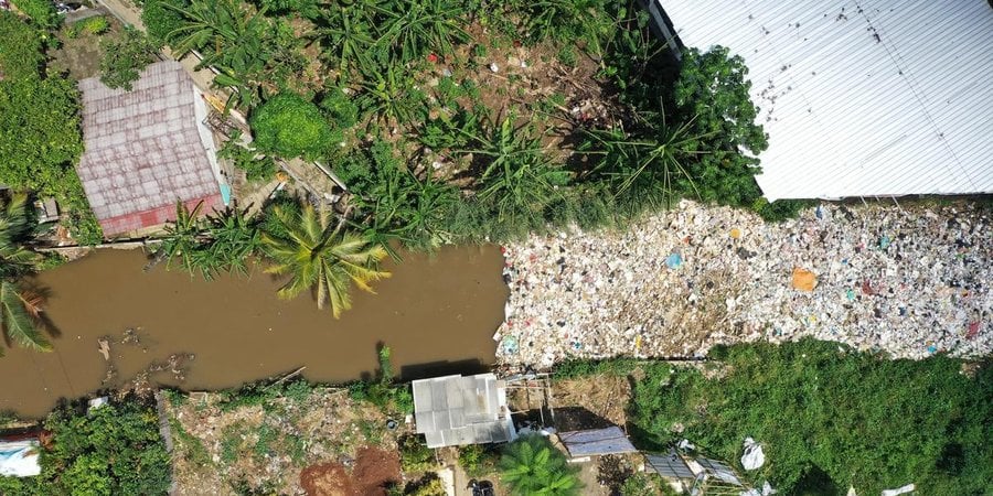 Aerial photo of a river clogged by plastic waste