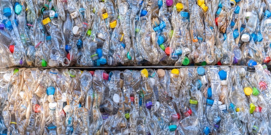Close-up of recycled plastic bottles that have been crushed into cubes.