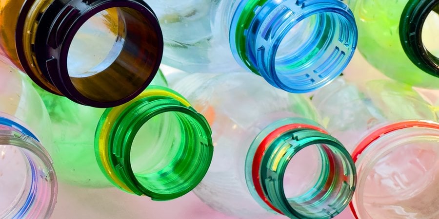 close up of colorful plastic bottle necks
