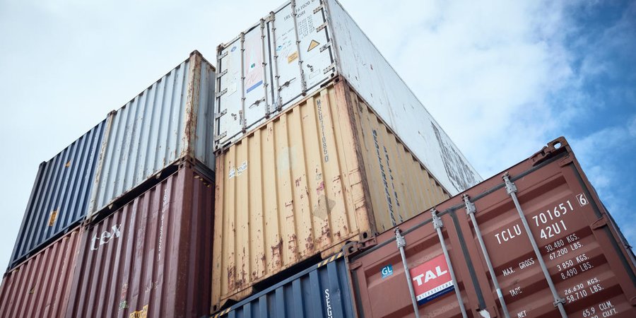 Looking up at stacked shipping containers