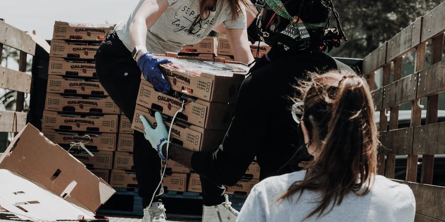 people unloading food from a truck