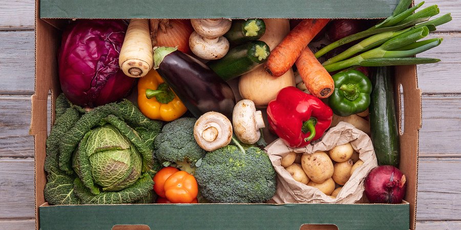 A large box full of colorful vegetables.