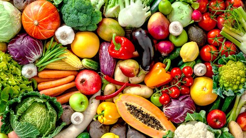 A table of assorted vegetables and fruits.